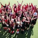 Sporty pupils from Sacred Heart Catholic Primary School show off their silverware Photo: DANIEL MARTINO