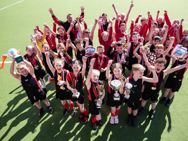 Sporty pupils from Sacred Heart Catholic Primary School show off their silverware Photo: DANIEL MARTINO