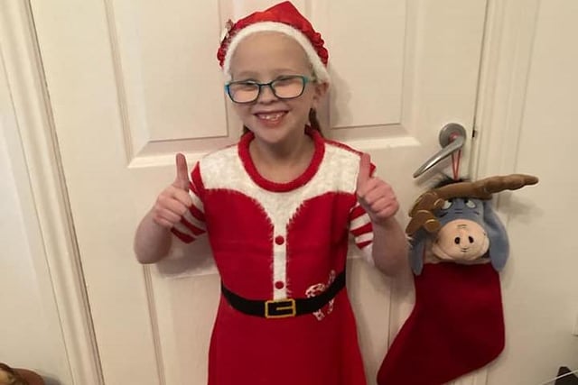 Lucy Rose McCormick, age 7, looking the part for Christmas Jumper Day in her Santa-themed outfit.