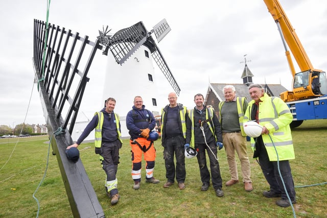 ...and here he is (right) with the team working on restoring the sails to the windmill