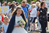 Members of the community take part in the Freckleton Club Day procession through the village.