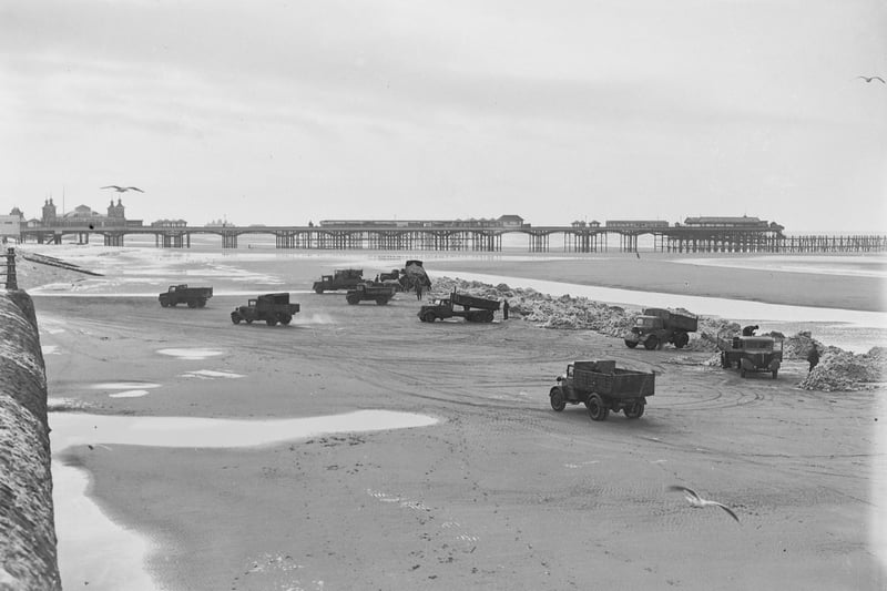 Army trucks moving snow from the Promenade onto the beach