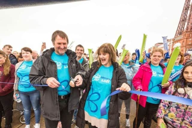 In 2018, Anne Nolan, whose mother Maureen had dementia, and ex-Blackpool football player Dave Serella, who is living with dementia, cut the ribbon to open that year's Blackpool Memory Walk (Photo: Chris Bull)