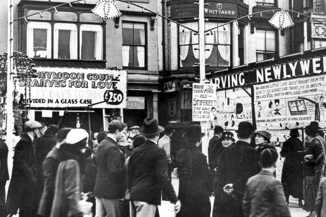 Roll up, roll up and pay to see starving honeymoon couples inside glass cases in the early 1930s. Those were the days when sideshows made their mark on the Golden Mile. Notice the lamp post placard for the defrocked Rector of Stiffkey, who was also starving - this time in a barrel