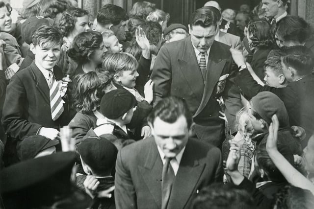 Members of the Blackpool team leaving St Annes Town Hall after their civic reception. In the foreground is John Crosland and behind him is Allan Brown.