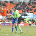 David Ferguson heads home a stoppage-time equaliser for the nine men of Blackpool
