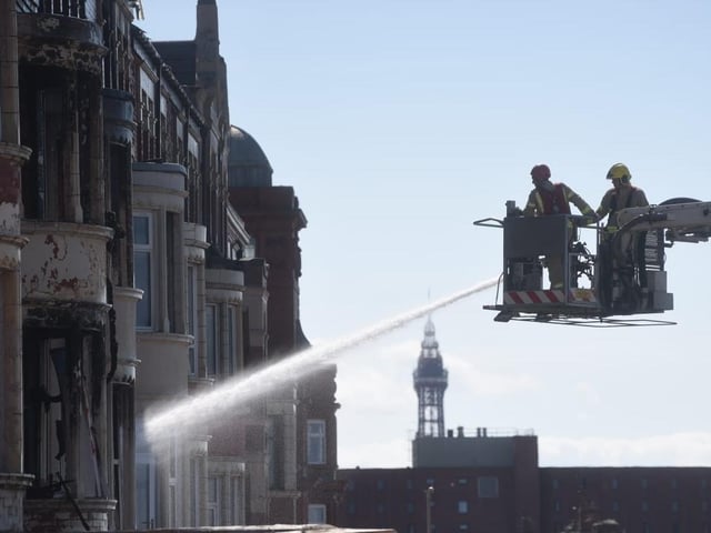 Firefighters continue damping down remaining hotspots at New Hacketts Hotel. Photo: Dan Martino