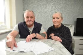 Keith and Lynne Milnes with paperwork covering the refund bid for their cancelled trip to Thailand