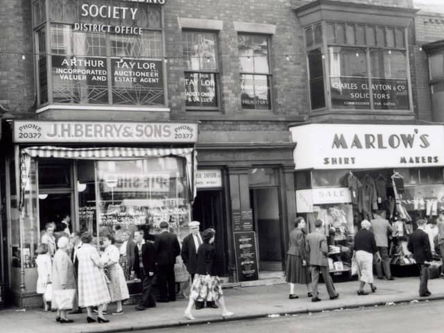 Talbot Road - south side between Abingdon Street and Topping Street. J.H. Berry & Son pork butcher and pie shop, Marlow's outfitters, Norwich Building Society, Charles Clayton and Co solicitors