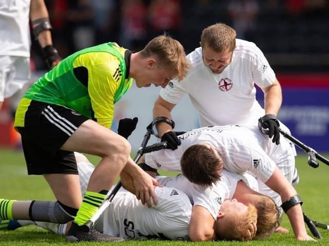 England teammates congratulate goalscorer Jamie Oakey (on his back) in Poland