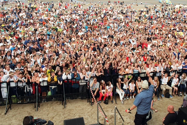 D.J. Dave Pearce throws freebies to massive crowds on the beach, 1999