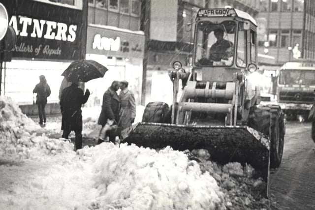 A strange sight for Blackpool as a bulldozer clears a path for cars in the town centre during heavy snowfall in 1981