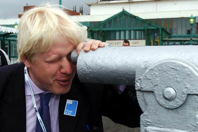 Boris Johnson looks through a telescope on North Pier in 2005 on the first day of the Conservative Conference in Blackpool