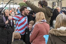 Radio 1 DJ Jordan North is greeted by Greg James after completing his 100-mile Comic Relief rowing challenge