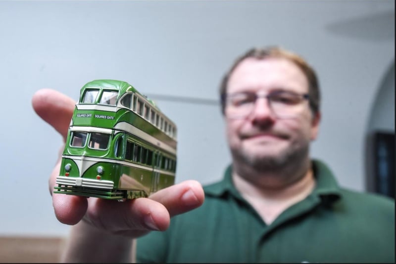 Exhibition organiser Jon Whitehouse with a model of a Blackpool tram.