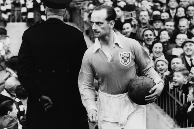 Blackpool Football Club captain Harry Johnston runs in to the ground holding the game ball at the start of a match against Tottenham Hotspur FC, Birmingham, March 21st 1953