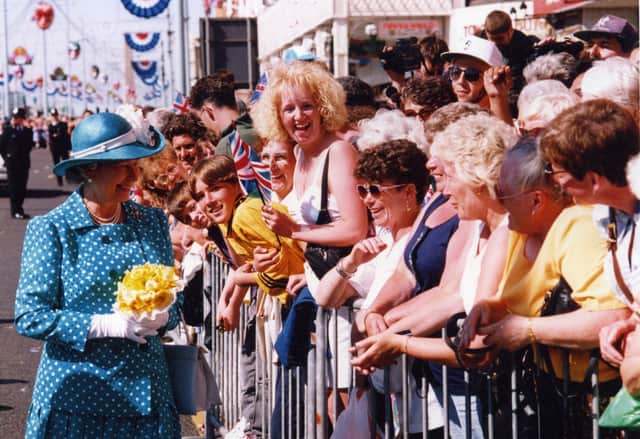 The Queen greets the crowds during a walkabout outside Blackpool Tower, 1994