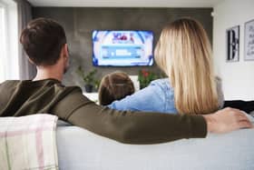A family enjoy TV together.