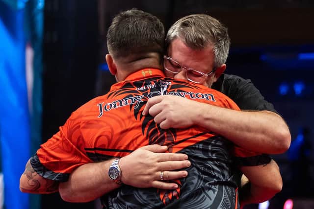 James Wade embraces Jonny Clayton after beating him in a tie-break in their Betfred World Matchplay semi-final at the Winter Gardens Photo: Taylor Lanning/PDC