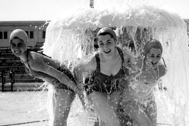 Girls shelter under the water mushroom at the South Shore Open Air Pool in 1955