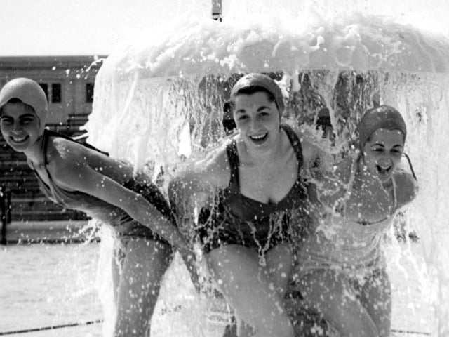 Girls shelter under the water mushroom at the South Shore Open Air Pool in 1955