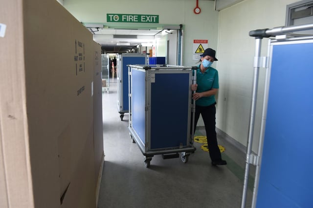 Containers of food are wheeled around the corridors of the hospital