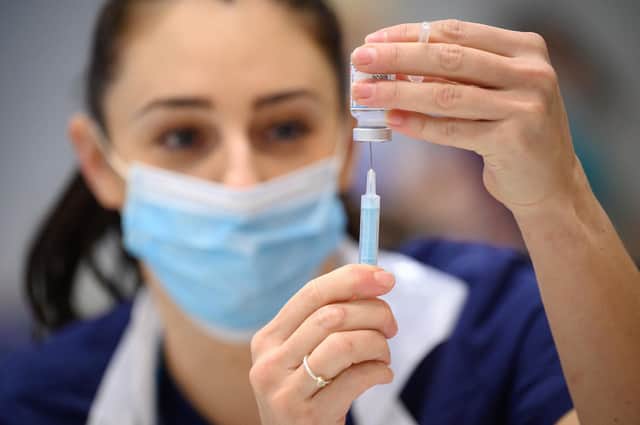 Medical staff prepare shots of the Moderna vaccine