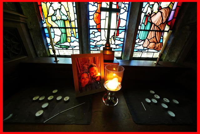 A candle is lit in front of a photo of Nicola Bulley  and her partner Paul Ansell on an altar at St Michael's Church, as police continue their search. Photo: Peter Byrne/PA Wire