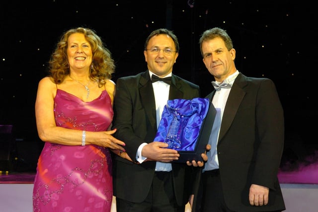 Martyn Collins of Front Desk (middle) presents Estelle Livesey and Darren Livesey of The Beach House Hotel with the Self Catering Holiday of the Year award, 2006