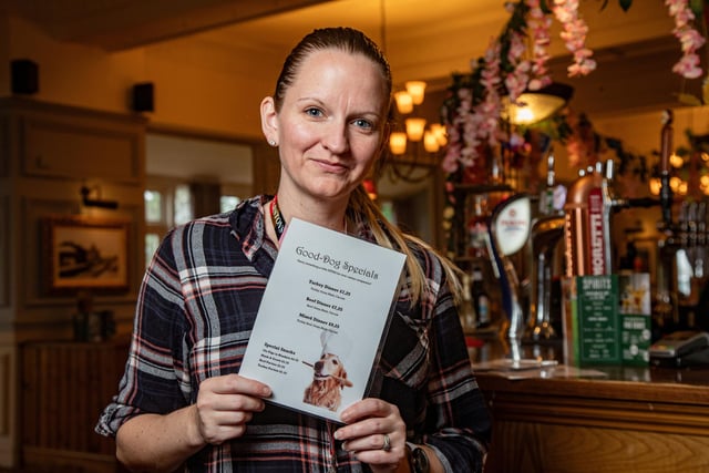 Heather Porter-Brandwood, general manager, holds up one of the dog menus.