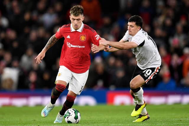 Manchester United's Argentinian defender Lisandro Martinez (L) vies with Charlton's English midfielder Albie Morgan (R) during the English League Cup quarter final football match between Manchester United and Charlton Athletic, at Old Trafford, in Manchester, north-west England on January 10, 2023.