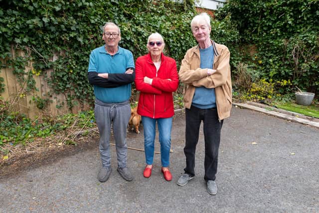 (l-r) Residents David Rushforth, Barbara Firth and Ian Morris in the remains of the garden which was destroyed by the contracted grounds team.   They say flowers have been removed and chopped away leaving just twigs and branches. Photo: Kelvin Stuttard