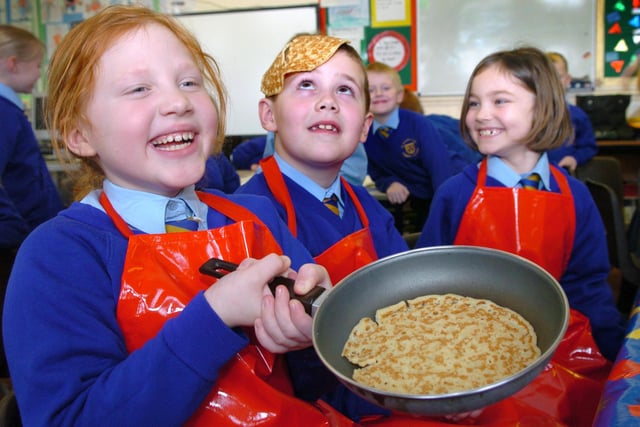 Pupils (from left to right) Katie Dixon, eight, Edward Farrer, seven, and Britney Myerscough, practice pancake tossing at St Nicholas School in Blackpool in preparation for Pancake Day