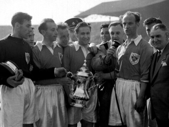 Joe Smith, Stanley Matthews and his teammates celebrate with the cup