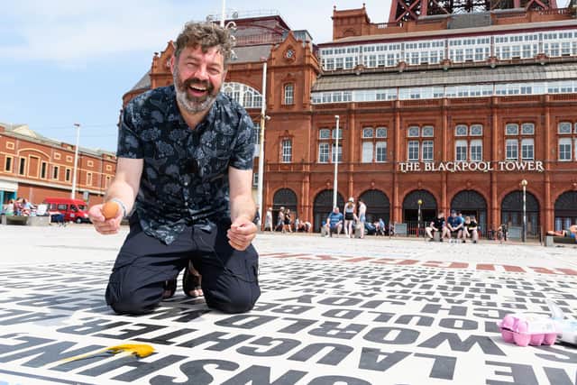 Reporter Richard Hunt laughs in dismay as the egg doesn't fry on the Comedy Carpet in Blackpool. Photo: Kelvin Stuttard