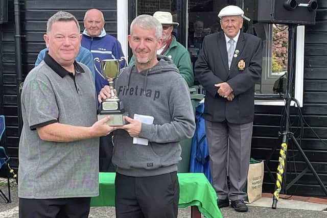 Autumn Waterloo champion Paul Dudley (right) receives the trophy from Waterloo bowls manager Mark Mills