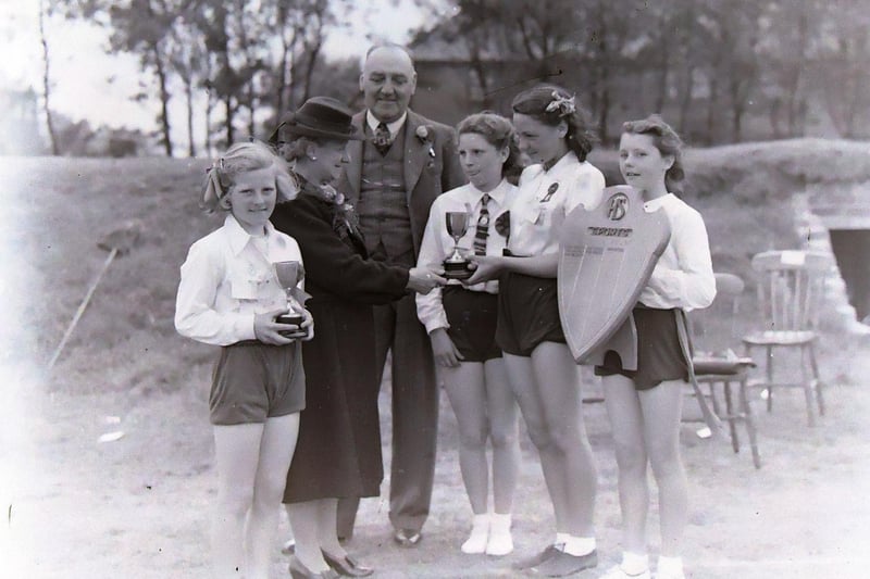 Highfield Girls Modern School sports day prizes presented by Councillor Mrs R Sudlow to junior champion Hilda Harrison (far left) and joint senior champions Louie Porter and Rita Randall in 1946