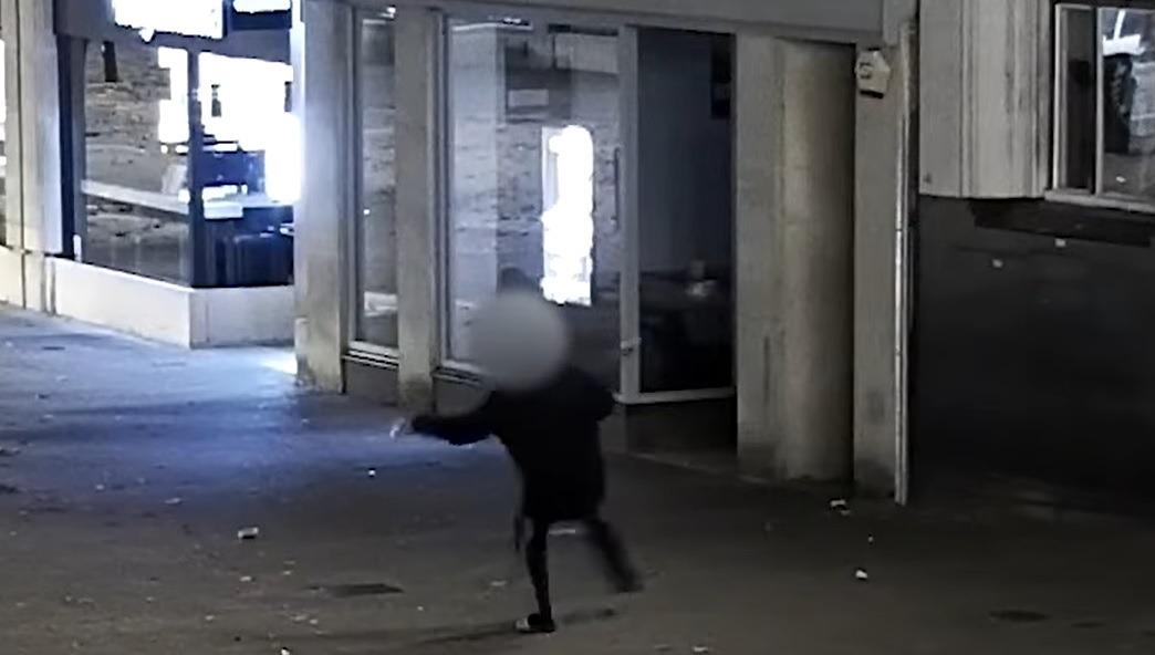 Caught on CCTV: Thug smashes Starbucks shop window with glass bottle