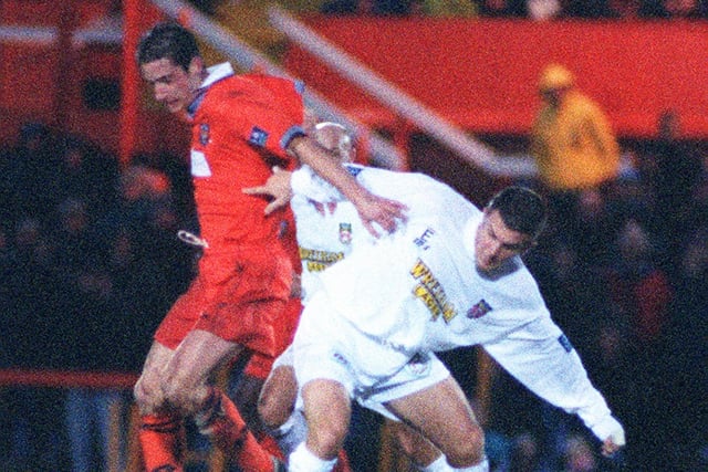 Blackpool's Ian Hughes gets in a tangle in a match against Wrexham. He helped Blackpool win the Football League Trophy at the Millennium Stadium playing as a substitute in the final