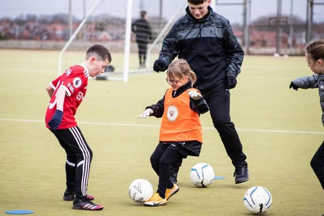Foundation degree student Rob Mellor coaching children with BFCCT