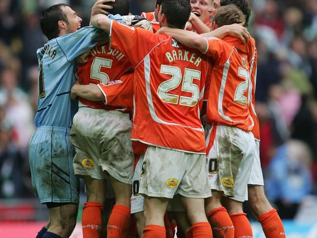 The Blackpool squad celebrate.