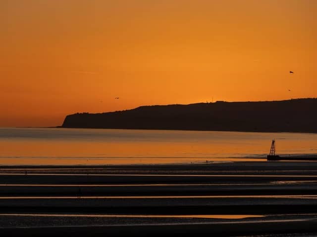The sun sets over Camber Sands.