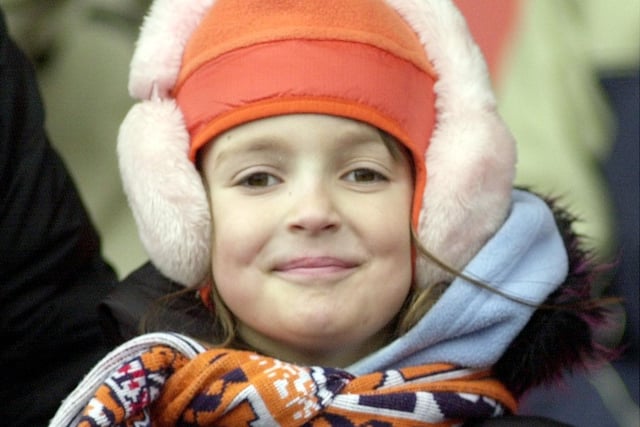 The opening of Blackpool Football Club new Stadium at Bloomfield Road, 2002. One young fan finds a way to keep her ears warm!