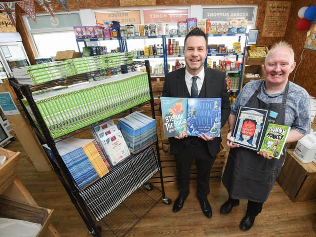 Peter Wright and Chris Lowry with books donated to the Community Grocery in Blackpool