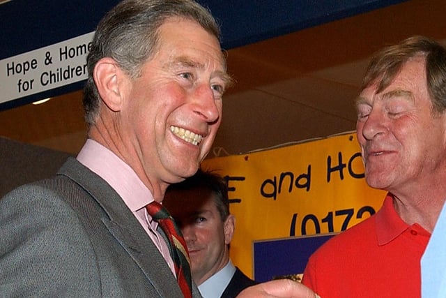Prince Charles enjoying a shot of whisky at one of the exhibition stands at the Rotary Conference in 2003