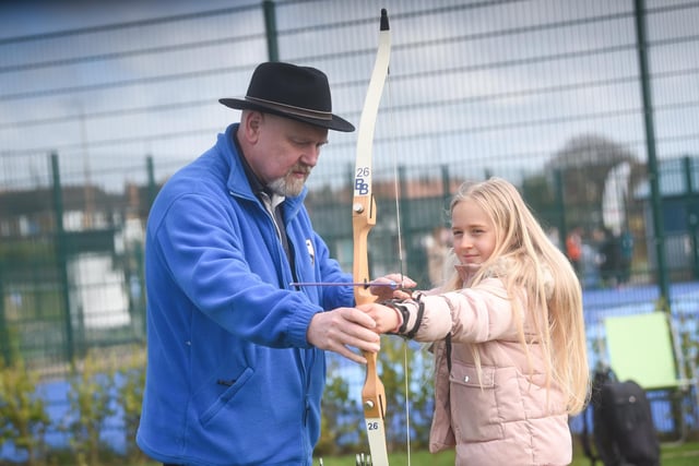 Paul Sykes from Blackpool Bowmen gives some archery instruction to  Hollie Fenwick at the Fairhaven Lake open day.
