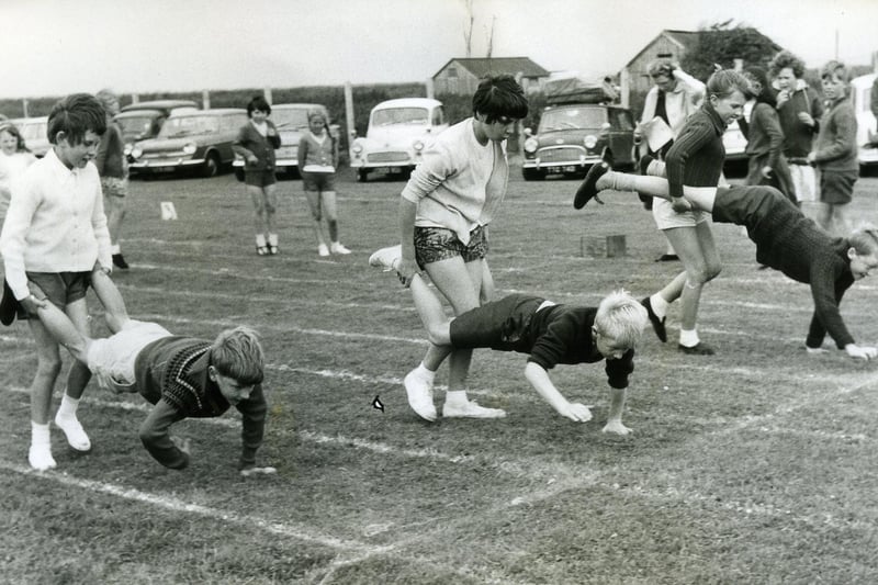 The start of the upper junior wheelbarrow race for boys and girls at Carters Charity School sports day, 1966