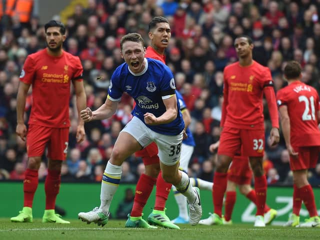 TOPSHOT - Everton's English defender Matthew Pennington (2nd L) celebrates after scoring their first goal during the English Premier League football match between Liverpool and Everton at Anfield in Liverpool, north west England on April 1, 2017.