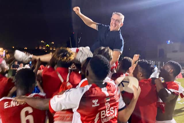 Owner Andy Pilley is celebrated by the Fleetwood United players on their promotion Picture: FLEETWOOD TOWN