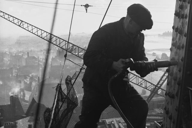 23rd February 1937:  A riveter carrying out repairs in preparation for the coming holiday season